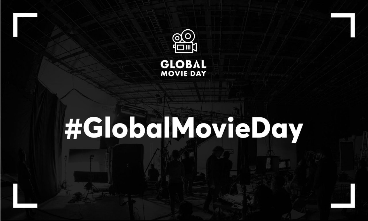 A black and white slate on which you may read # Global Movie Day.